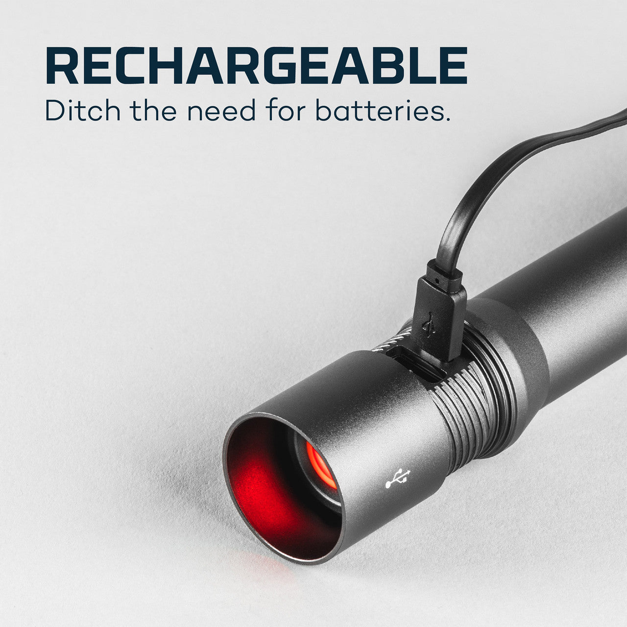 Rechargeable flashlight with a red lens and attached power cord.