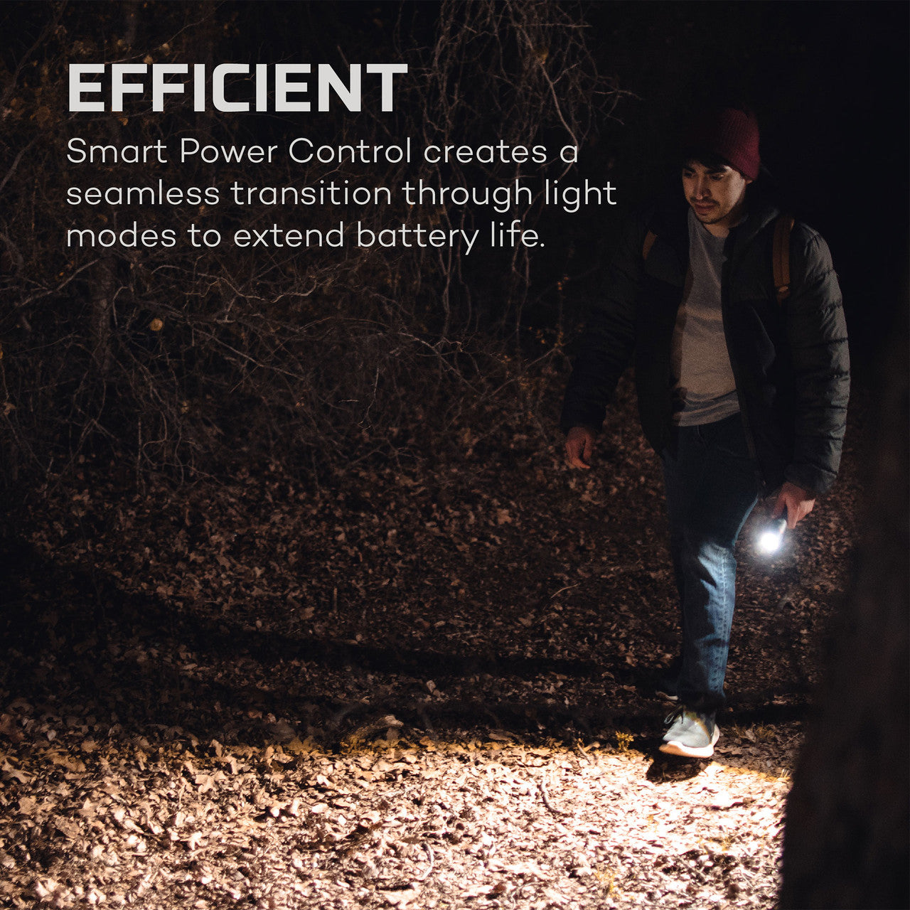 Person using a flashlight in a dark outdoor setting.