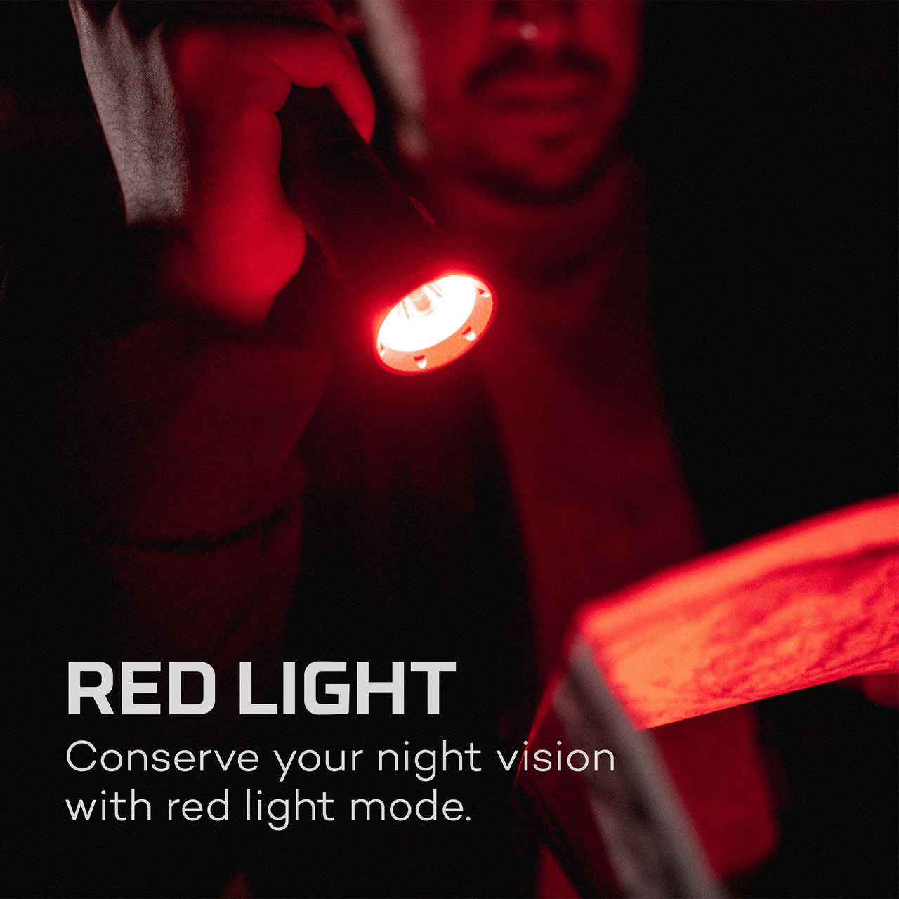 Handheld flashlight emitting red light, with text explaining its night vision conservation feature.