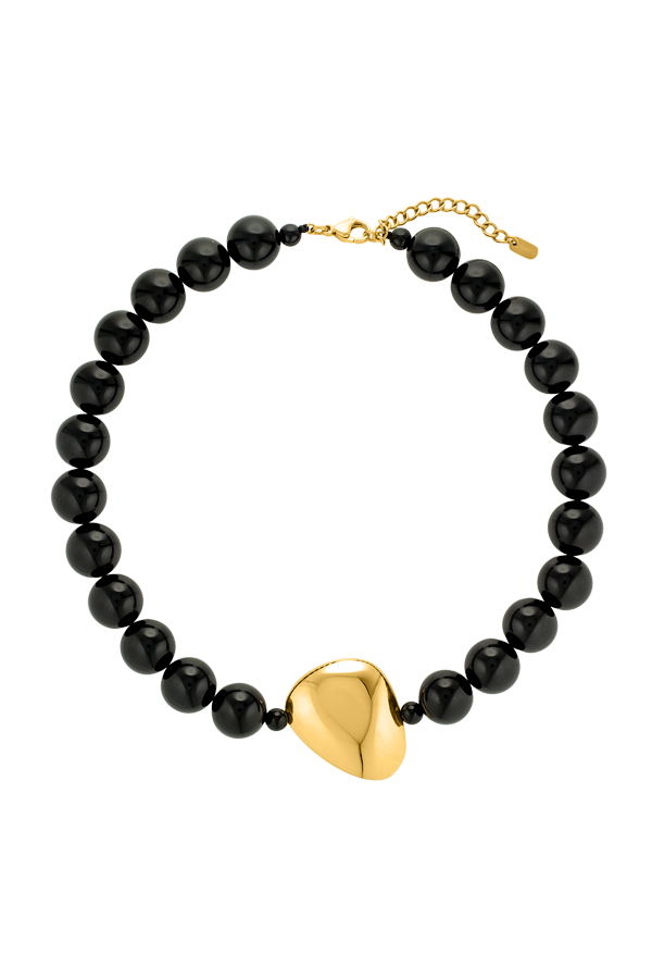 Cendré Plaza black resin bead necklace with gold pendant on a white background