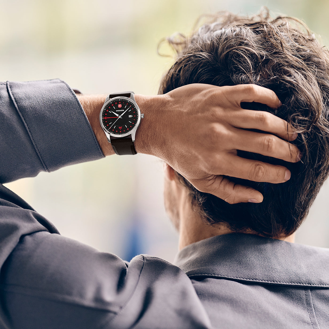 Lifestyle image of the Wenger City GMT 42 01.1442.102 black dial watch on its black silicone strap
