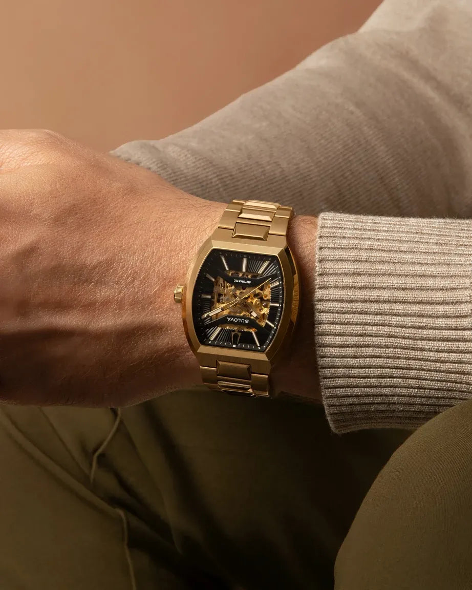 Bulova Maquina 97A207 automatic men's watch with skeletonised black dial and gold-tone stainless steel bracelet — caseback view