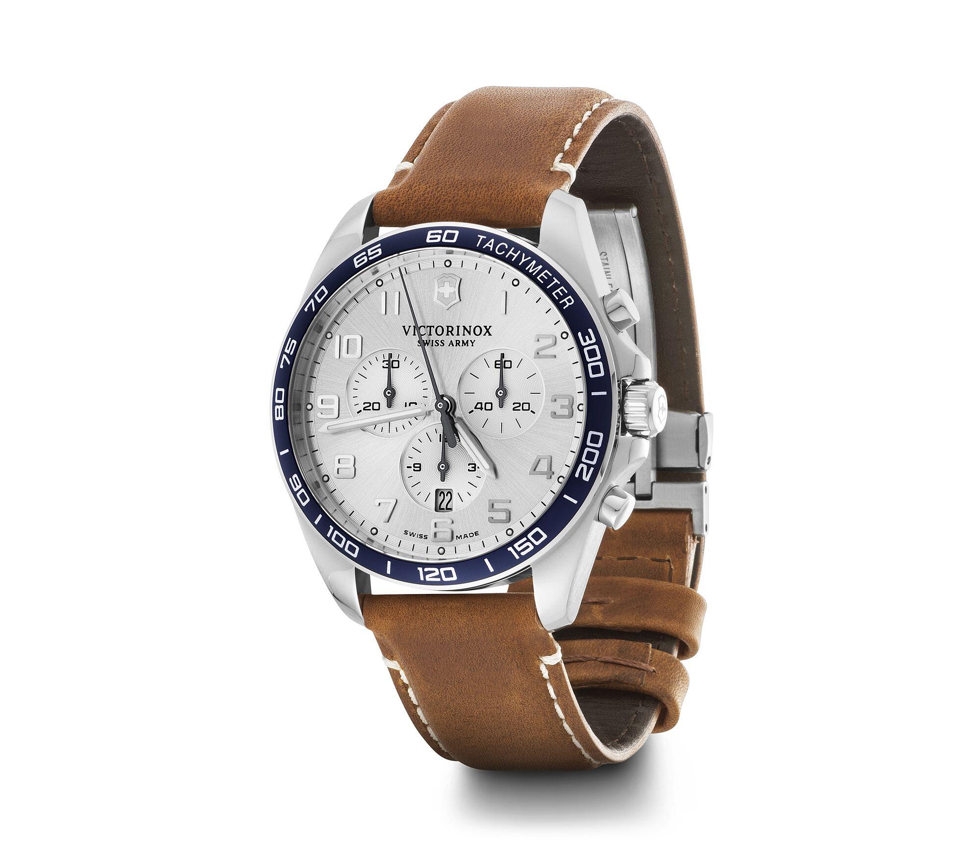 Wristwatch with a brown leather strap, white dial, and blue bezel.