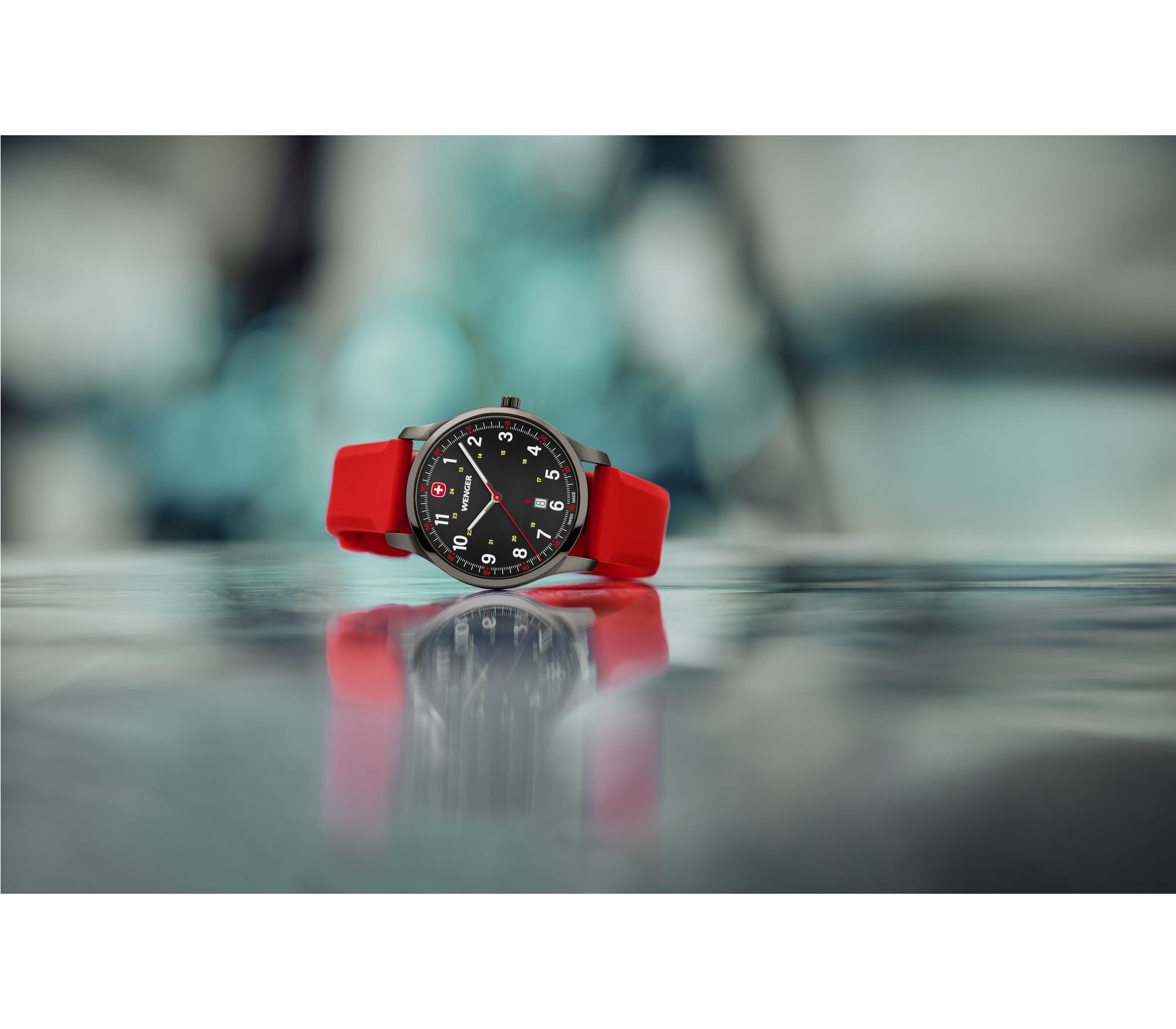 Wristwatch with a black face and bright red strap.