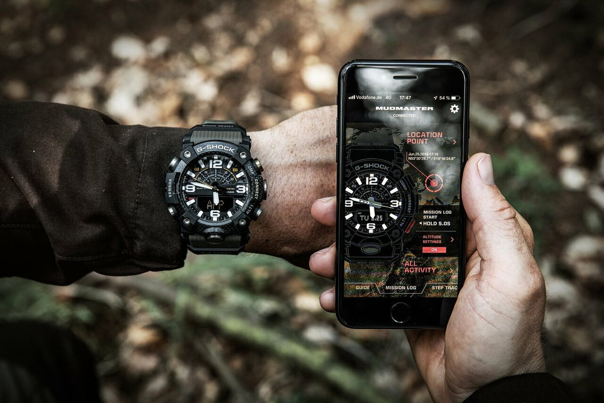 G-Shock Mudmaster worn on the wrist beside a smartphone running a watch app