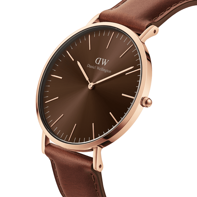 Elegant wristwatch with a brown leather strap and rose gold-toned case featuring a minimalist brown dial.