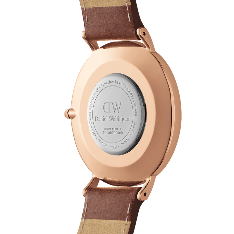 Rose gold wristwatch with a brown leather strap.