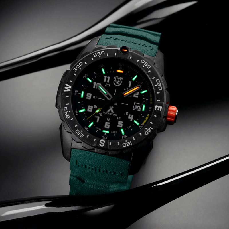 Rugged sports watch with a black case, green strap, and luminous dial markings.