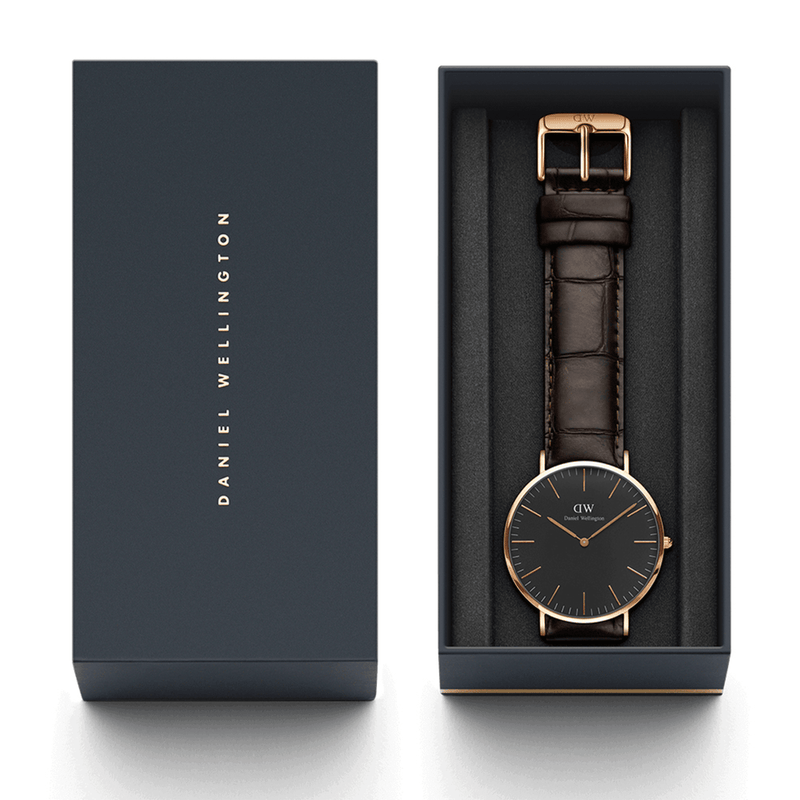 Elegant wristwatch with a black face and brown leather strap in a gift box.