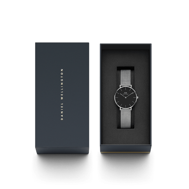 Sleek wristwatch with a black face and mesh metal band in an open gift box.