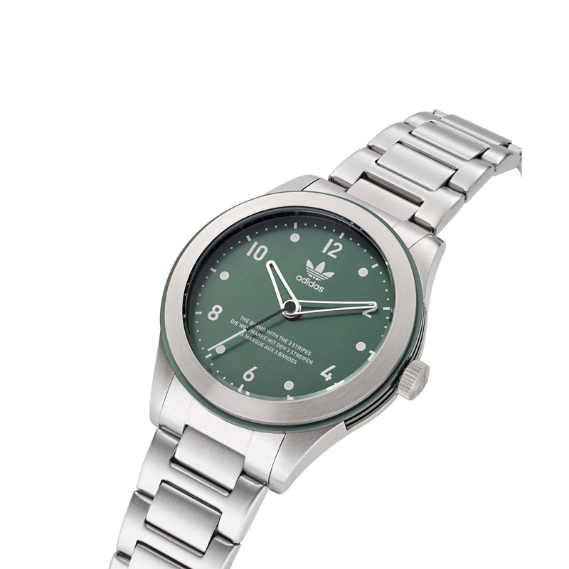 Silver wristwatch with a green dial featuring the Adidas trefoil logo.