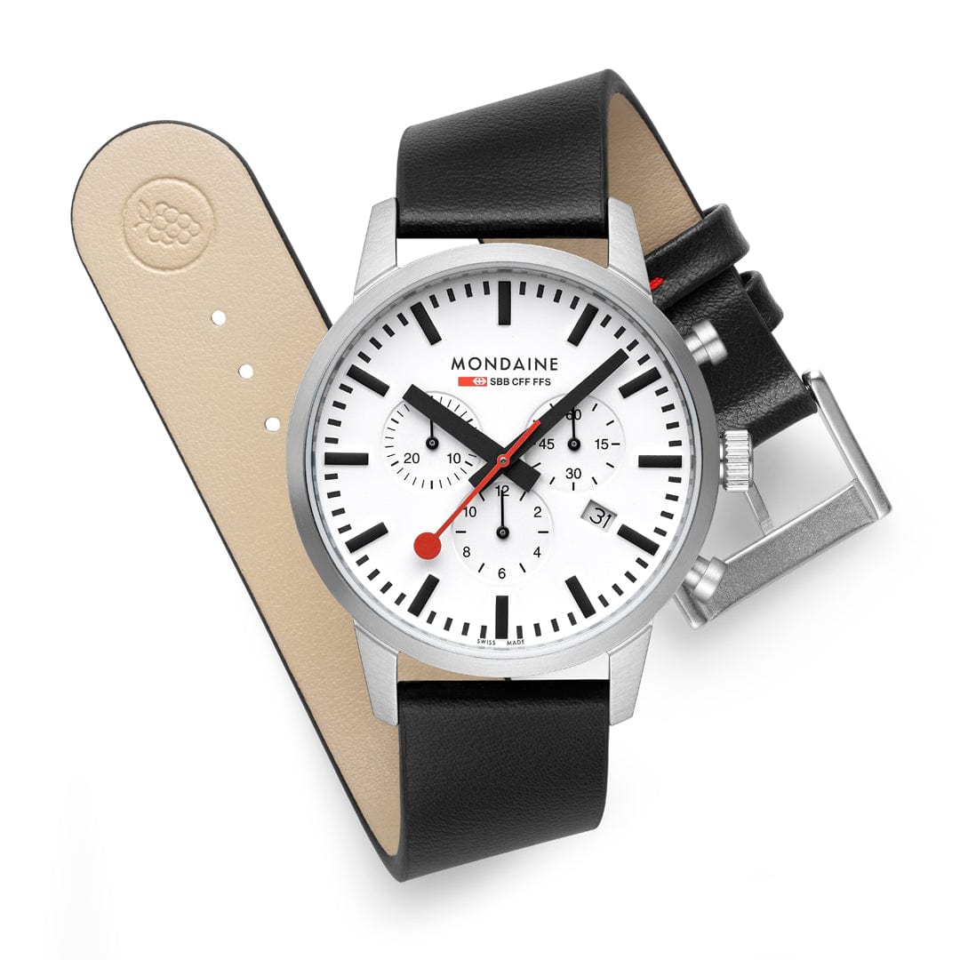 Mondaine wristwatch with a white dial, chronograph subdials, and a black leather strap.