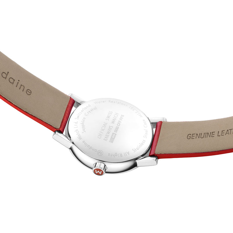 Wristwatch with a silver case and tan leather strap featuring red accents.