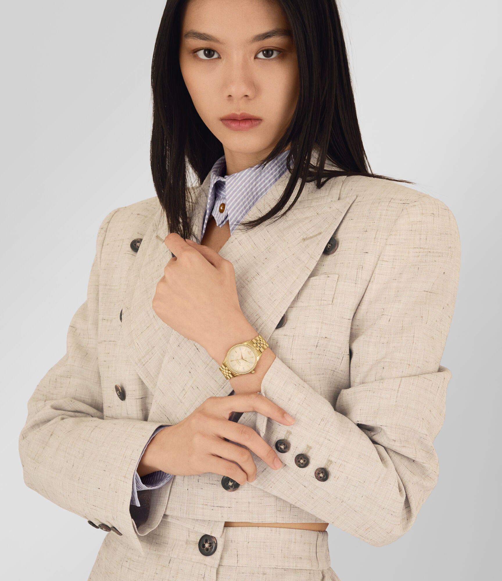 Vivienne Westwood Little Wallace women's watch with a gold dial and gold stainless steel bracelet. Shown at an angle.