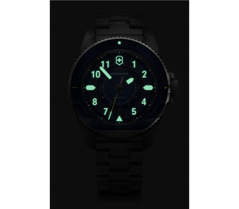 Luminous analog watch face displaying 11:30 in a dark setting.