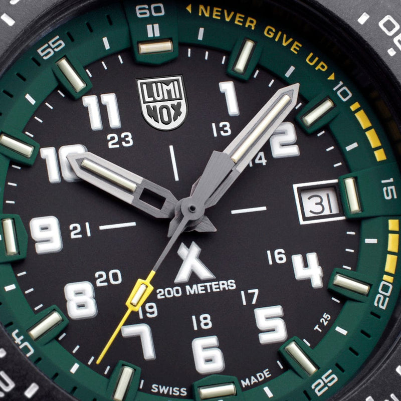 Close-up of a green and black analog watch face with luminous markings and hands.