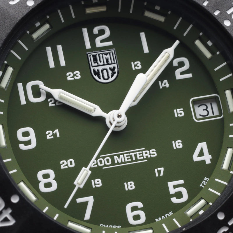 Green-faced analog wristwatch with luminous markings showing 10:10.