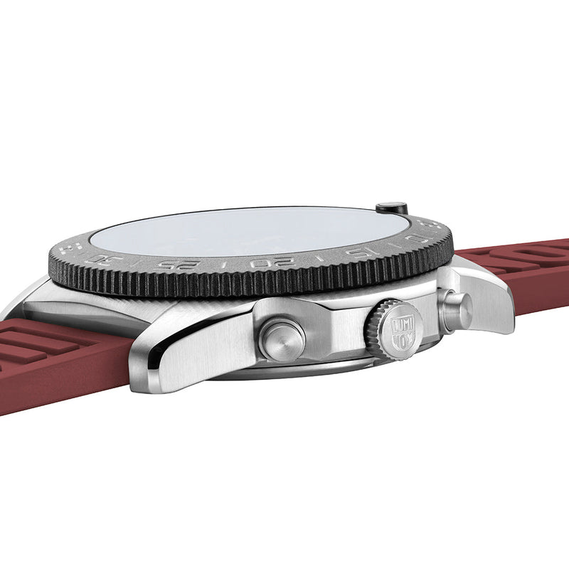 Wristwatch with a burgundy leather strap and textured bezel.