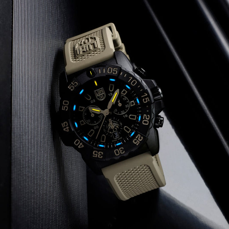 Rugged sports watch with a black face, blue accents, and a tan rubber strap.