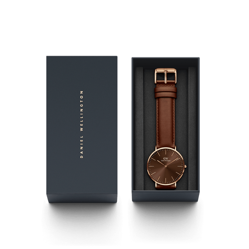 Elegant wristwatch with a brown leather strap and rose gold-toned case in a presentation box.