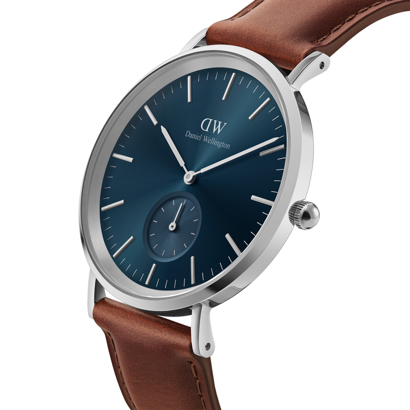 Sleek wristwatch with a blue dial, silver case, and brown leather strap.