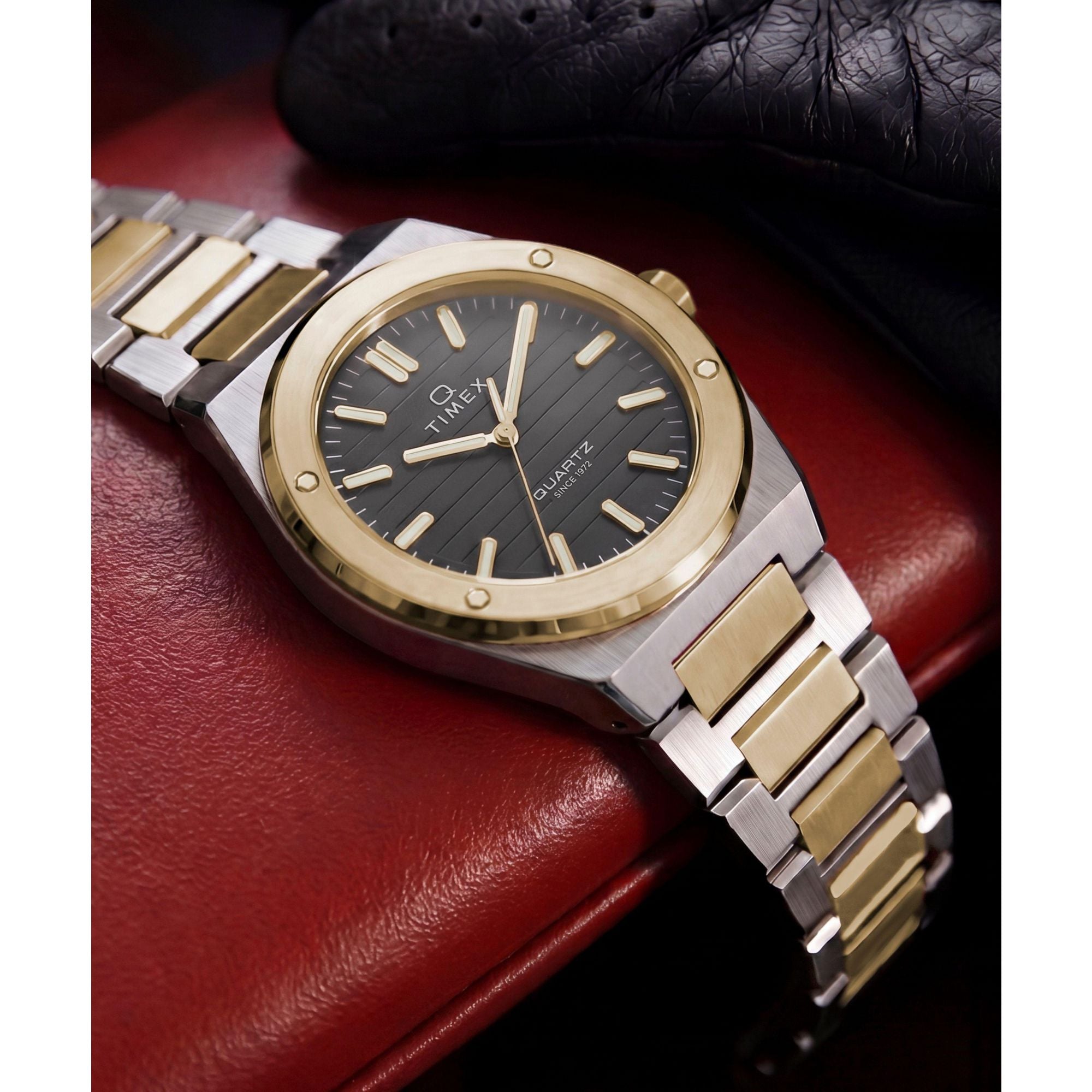 Timex Q Timex TW2Y81500 black ribbed dial with gold markers on a two-tone bracelet, styled detail