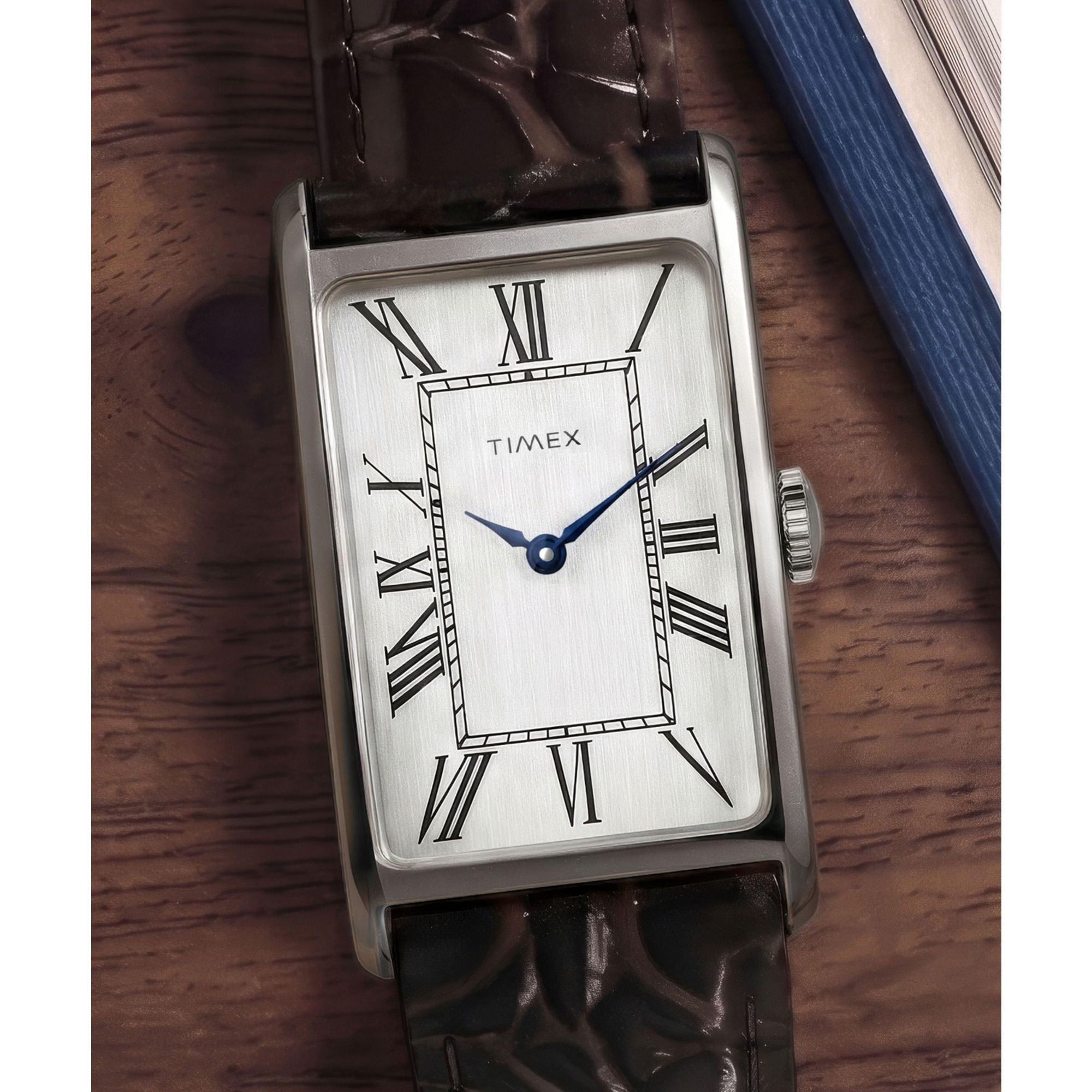 Timex 1976 Lexington TW2Y88200 silver dial with Roman numerals on a brown leather strap, styled detail