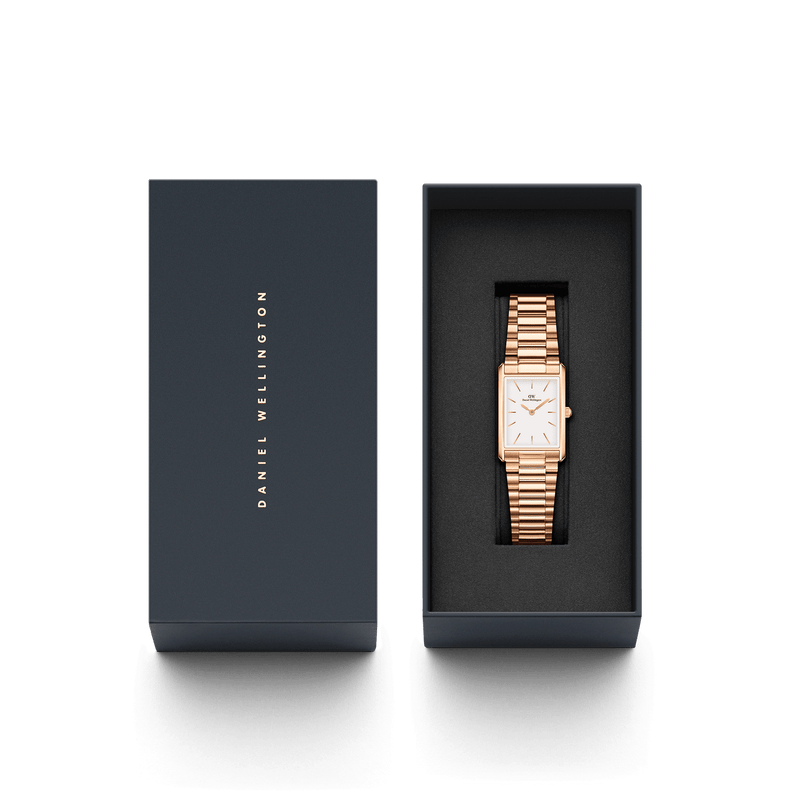 Gold-toned rectangular wristwatch with a metal link bracelet in a black presentation box.