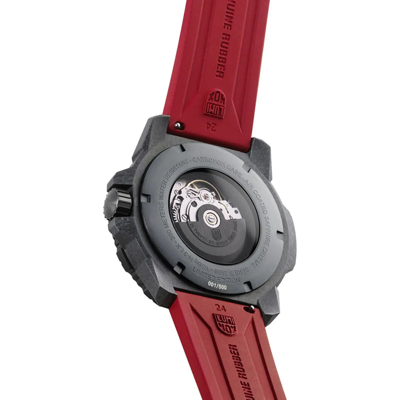 Back of a wristwatch with a red strap and visible mechanical components through a transparent case back.