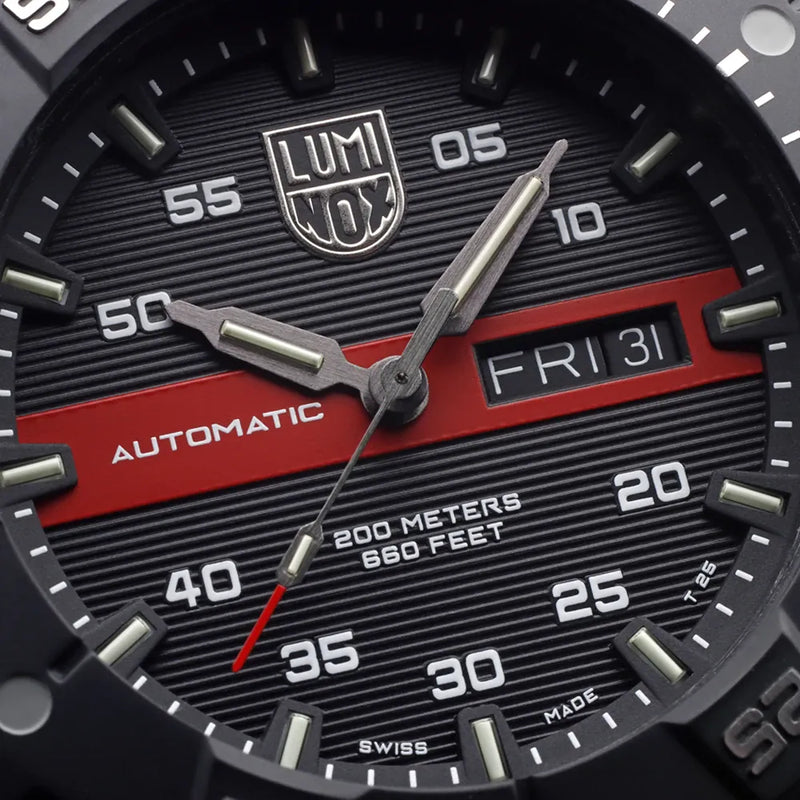 Close-up view of a Luminox automatic wristwatch face showing time and date.