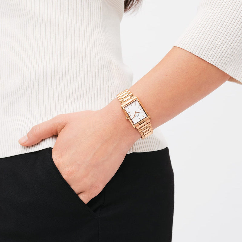 Gold-toned wristwatch with a square face and link bracelet.