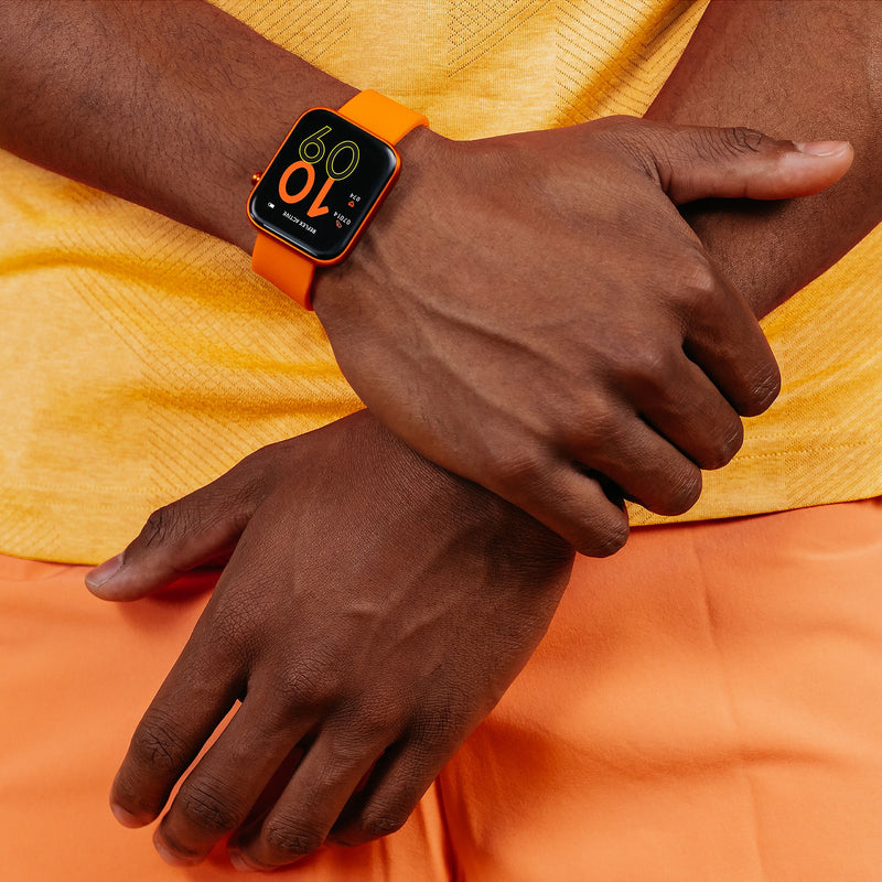 Orange smartwatch with a black digital display worn on a wrist.