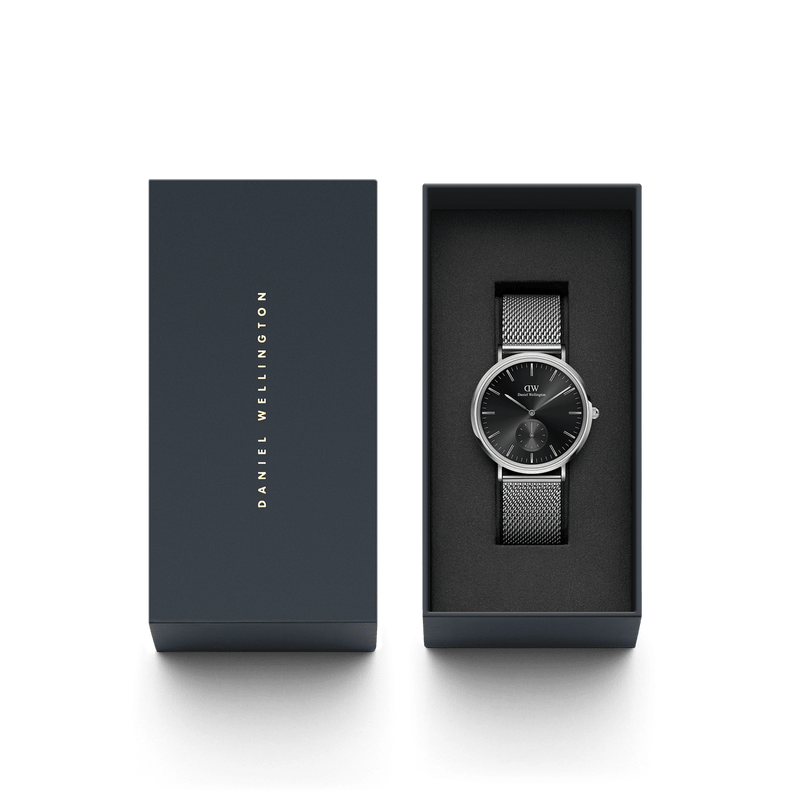 Sleek wristwatch with a black face and mesh metal band in an open gift box.