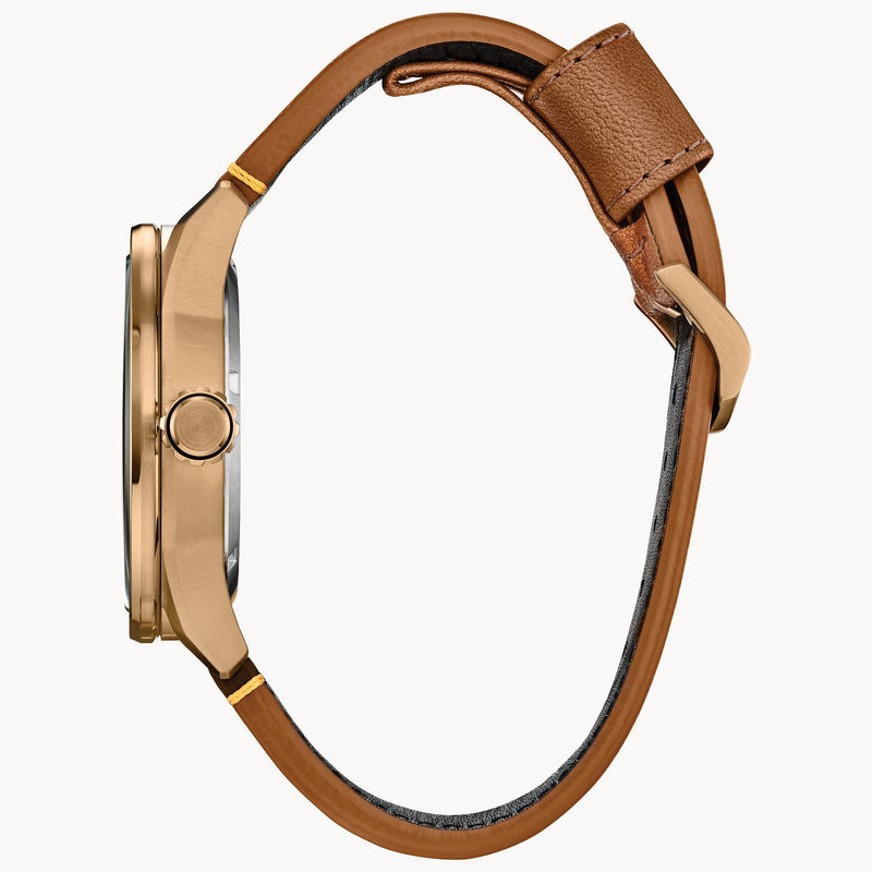 Wristwatch with a gold-toned case and brown leather strap.