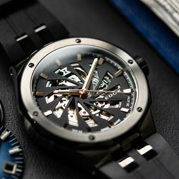 Luxury mechanical wristwatch with a skeleton dial and black strap.