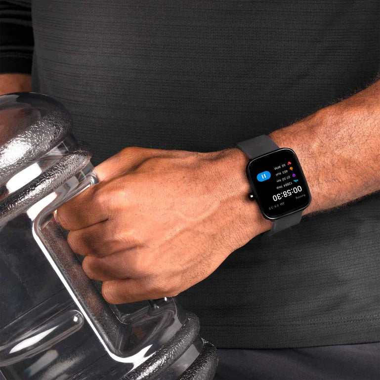 Smartwatch displaying time on a person’s wrist as they hold a water bottle.