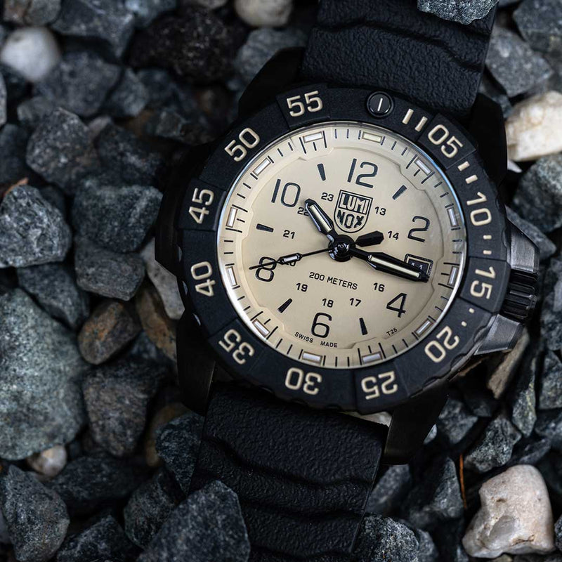 Rugged wristwatch with a black bezel and cream-colored dial displaying the Luminox brand.