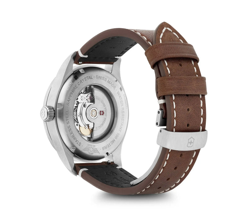 Wristwatch with a brown leather strap and visible mechanical movement through the transparent case back.