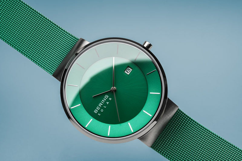 Wristwatch with a green dial and matching green mesh strap.