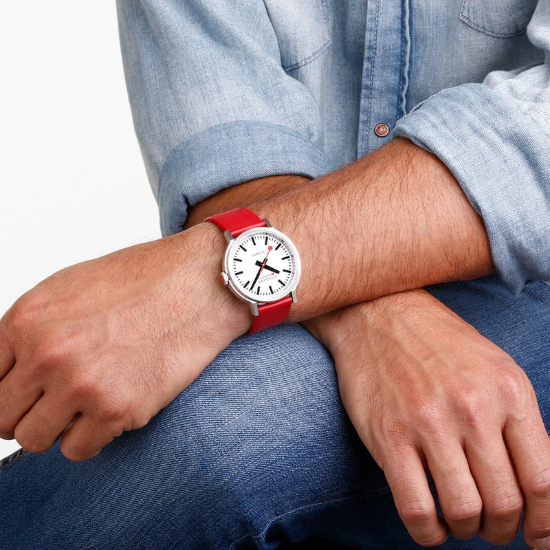 Wristwatch with a white face and bright red band.