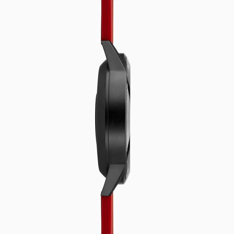 Side view of a sleek black wristwatch with a red strap.