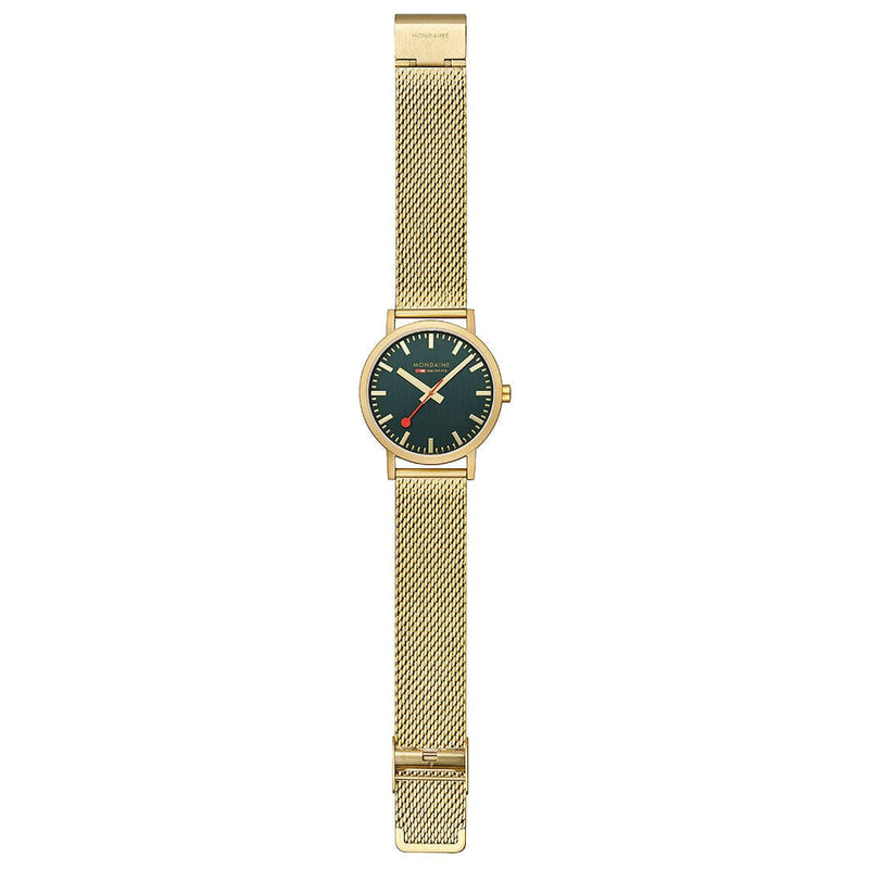 Gold-toned wristwatch with a green dial and mesh metal band.