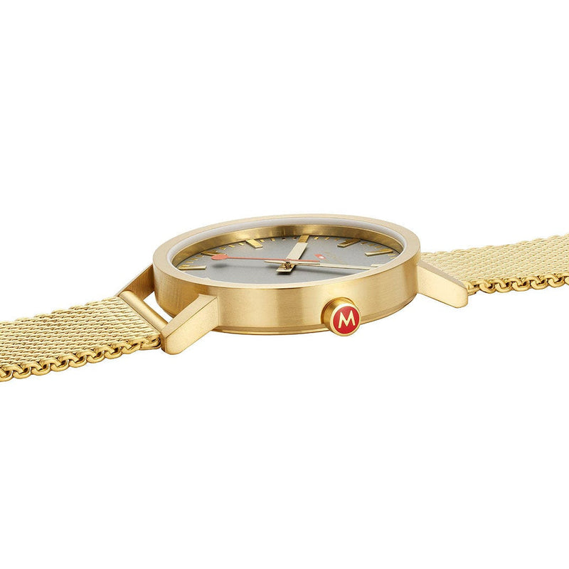 Gold-toned wristwatch with a mesh band and minimalist dial design.