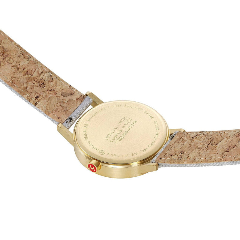 Wristwatch with a gold-colored case and cork-textured leather strap.