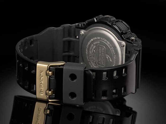 Rugged black digital wristwatch with a gold-toned buckle.