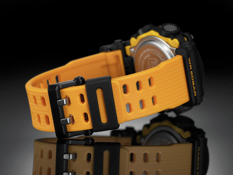 Yellow rubber watch band with a black buckle attached to a digital watch face.