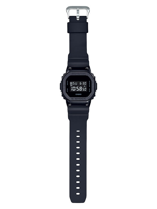 Digital wristwatch with a square black face and dark strap.