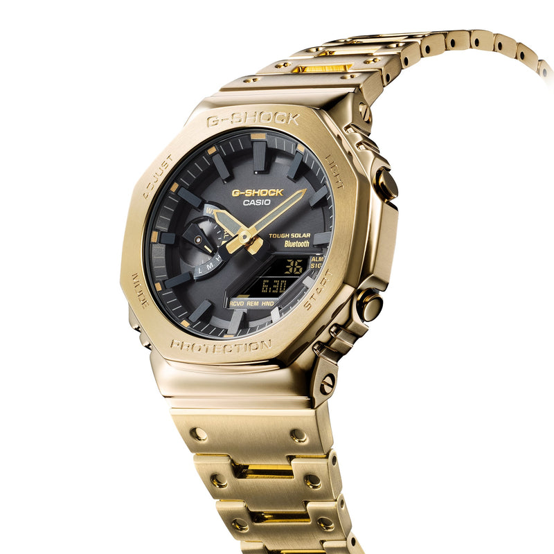 Gold-toned wristwatch with a dark face and digital display.