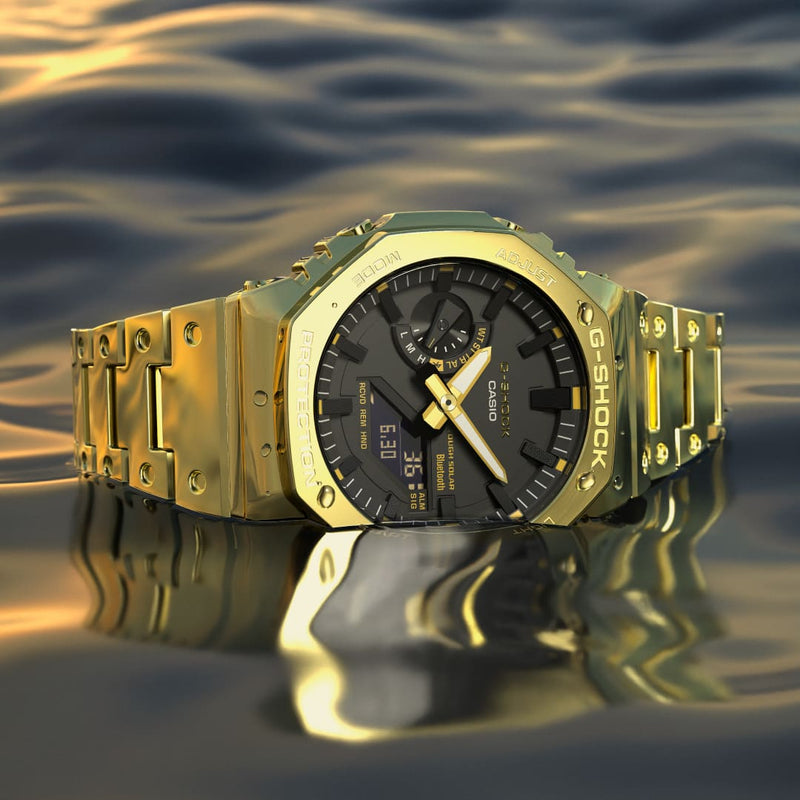 Gold-colored luxury wristwatch with a dark face and octagonal bezel.