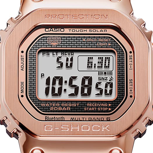 Rose gold Casio G-Shock digital watch with a square face displaying the time and various functions.